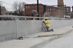 December 2021 - A worker finishes the concrete on the new Markley Street Bridge.