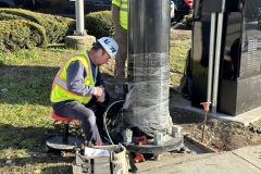 December 2022 - A worker wires a new traffic signal at the intersection of Main and Markley streets.