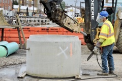 February 2020 - A worker cuts a section of concrete pipe that will be used for the sanitary sewer bypass.