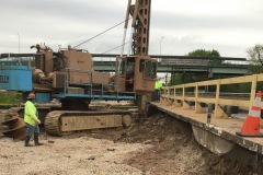 May 2020 - Workers drilling a caisson to support the foundation of the new northbound bridge over Stony Creek.