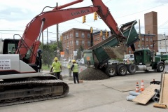 June 2020 - Workers backfill a utility trench.