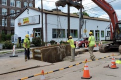 July 2020 - Workers install a trench box for utility construction on Markley Street.